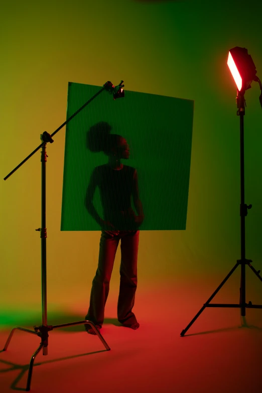 a man standing in front of a green screen, inspired by Carrie Mae Weems, color field, girl in studio, under a spotlight, promotional image, vibrant backlit