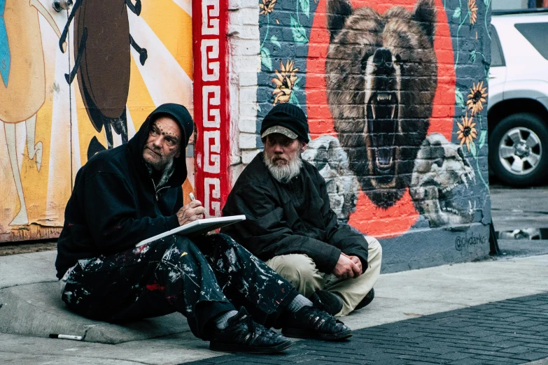 a couple of men sitting on the side of a street, by Lee Loughridge, pexels contest winner, street art, skilled homeless, da vinci and alphonse mucha, two aboriginal elders, jenny saville and nicola samori