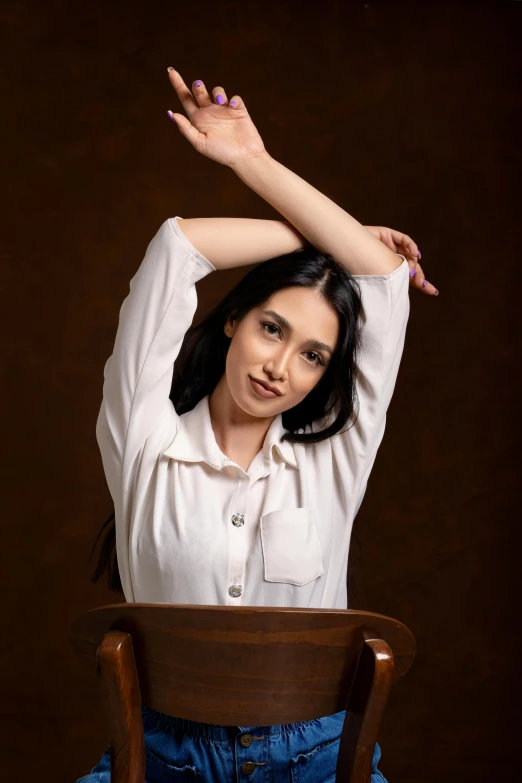 a woman sitting on top of a wooden chair, pexels contest winner, arabesque, wearing a light shirt, straight arms, full frame image, beautiful iranian woman