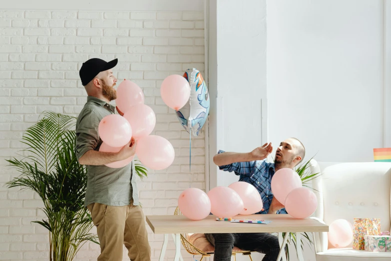 a man and a woman sitting at a table with pink balloons, satisfying, two buddies sitting in a room, the birth, profile image