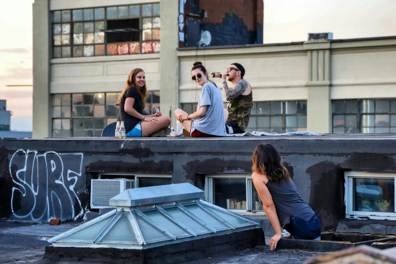 a group of people sitting on top of a roof, a photo, drinking and smoking, montreal, profile image, fzd school of design