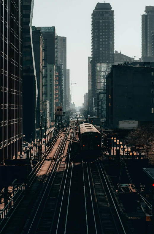 a train traveling through a city next to tall buildings, by Robbie Trevino, unsplash contest winner, chicago, gif, 4 k ], multiple stories
