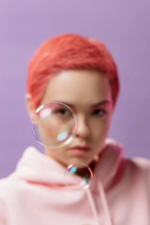 a woman in a pink hoodie blowing bubbles, an album cover, inspired by Yanjun Cheng, trending on pexels, pink short hair, close up. macro. hyper realistic, toys, cgsociety portrait