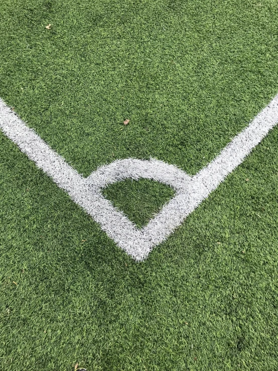 a baseball field with a white line painted on it, by Carey Morris, trending on dribble, fake grass, medium closeup, taken on iphone 1 3 pro, yinyang shaped