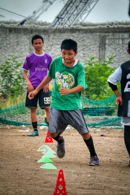 a group of young men playing a game of soccer, dribble, origin jumpworks, thailand, let's play, at full stride