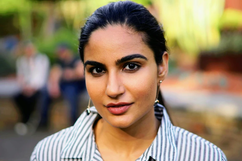 a close up of a person wearing a shirt, pexels, tanned ameera al taweel, dayanita singh, actress, big cheekbones