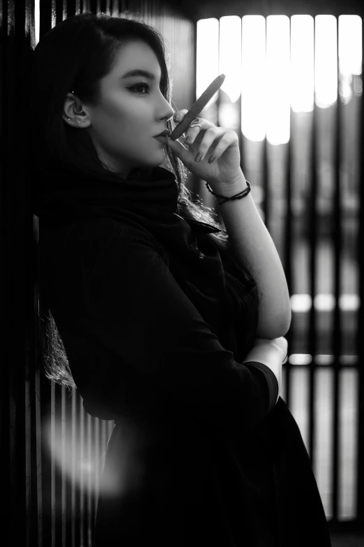 a black and white photo of a woman smoking a cigarette, inspired by irakli nadar, ameera al-taweel, casual pose, cinematic!!, monochrome:-2