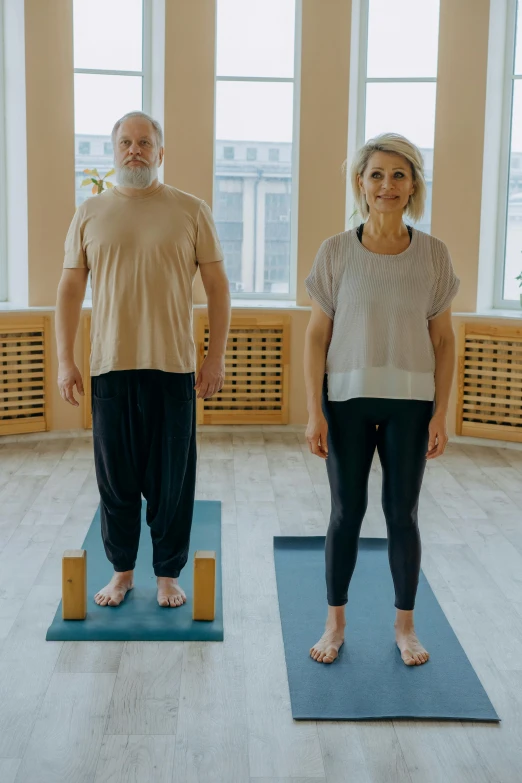 a man and a woman doing yoga together, portrait of hide the pain harold, standing up, wide film still, olga buzova