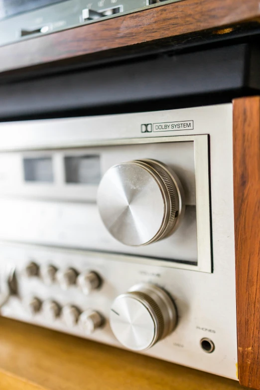 a stereo system sitting on top of a wooden table, by Everett Warner, unsplash, 7 0's kitchen, shiny knobs, detail shot, high key detailed