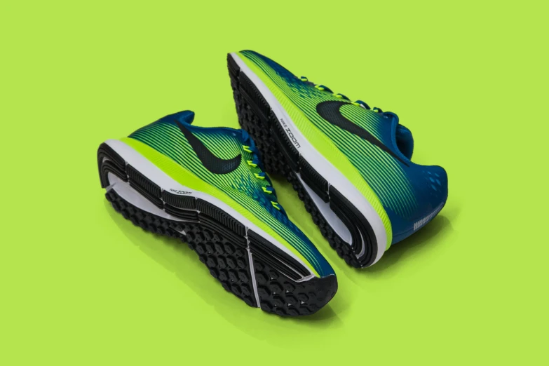 a pair of running shoes on a green background, inspired by João Artur da Silva, trending on dribble, black blue green, birdseye view, nike, size 1 0