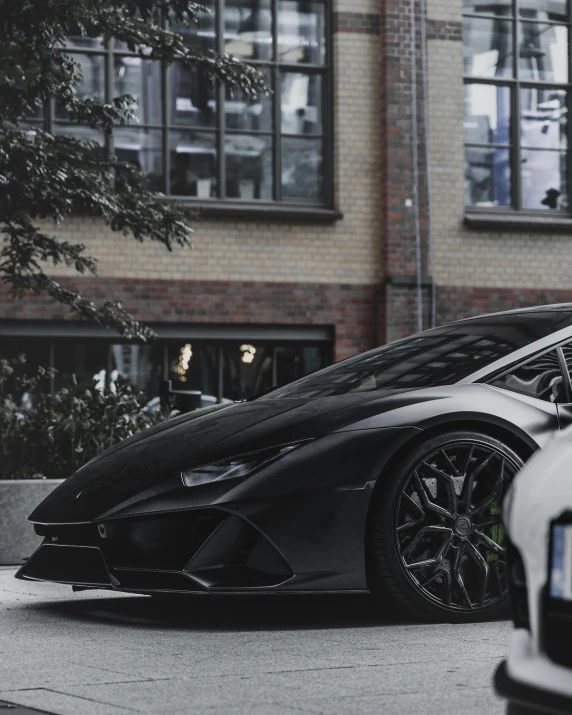 a black and white sports car parked in front of a building, trending on r/streetwear, lamborghini, top selection on unsplash, dressed in black
