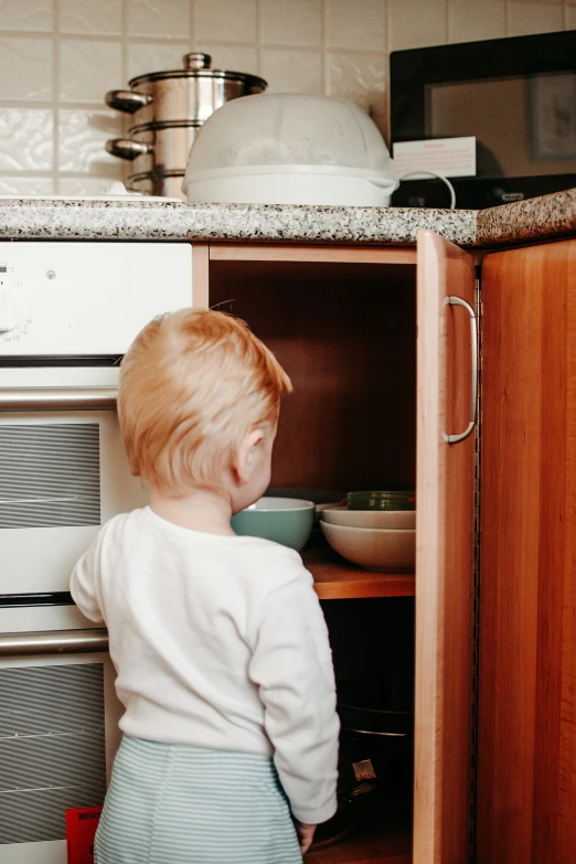 a little boy standing in front of an oven, pexels contest winner, happening, spying discretly, shelf, gif, square