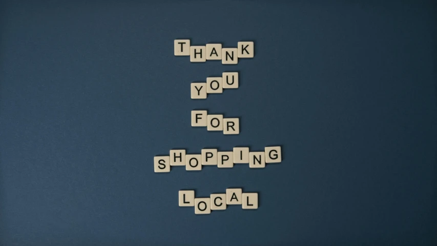 the words thank you for shopping spelled in scrabbles, an album cover, by Nick Fudge, local close up, blue, small, business
