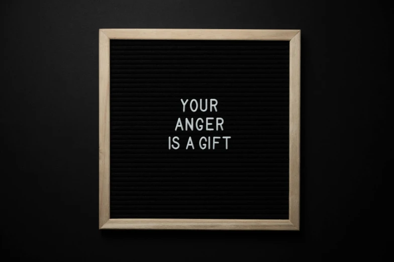 a letter board that says your anger is a gift, a picture, by Andries Stock, pexels, 1 6 x 1 6, black, design, cardboard