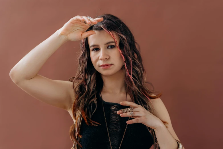 a woman with long hair posing for a picture, an album cover, by Julia Pishtar, trending on pexels, hurufiyya, coral brown hair, kailee mandel, holding a pudica pose, with brown hair