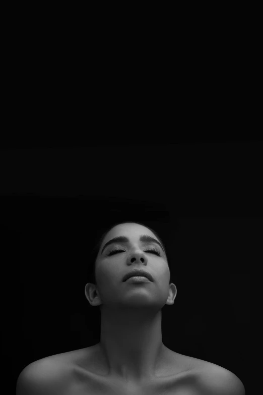 a black and white photo of a man with his eyes closed, by irakli nadar, unsplash, conceptual art, oona chaplin, symmetry!! portrait of a woman, young woman looking up, ffffound