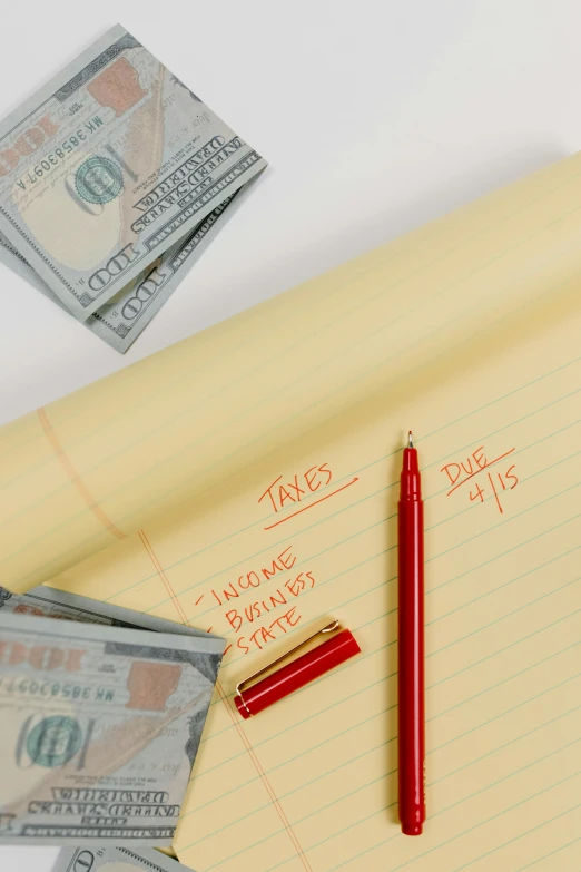 a red pen sitting on top of a piece of paper next to a stack of money, by Matt Cavotta, renaissance, thumbnail, multiple stories, rays, a labeled