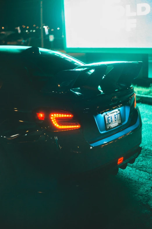 a car parked in front of a movie screen, by Matt Cavotta, unsplash, tail lights, subaru, full body backlight, tail fin