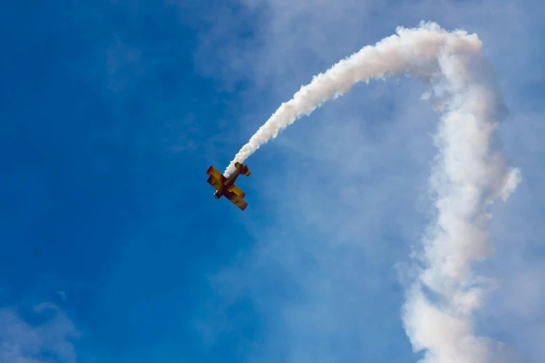 an airplane that is flying in the sky, a picture, by Jessie Algie, pexels contest winner, smokey cannons, massive vertical grand prix race, profile image, a wooden