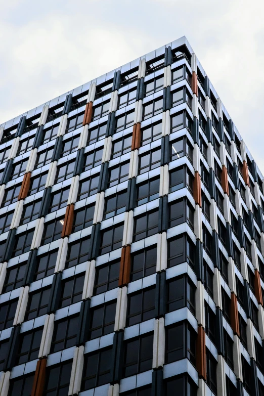 a very tall building with lots of windows, by Washington Allston, unsplash, modernism, dark grey and orange colours, zoomed in, squares, wikipedia