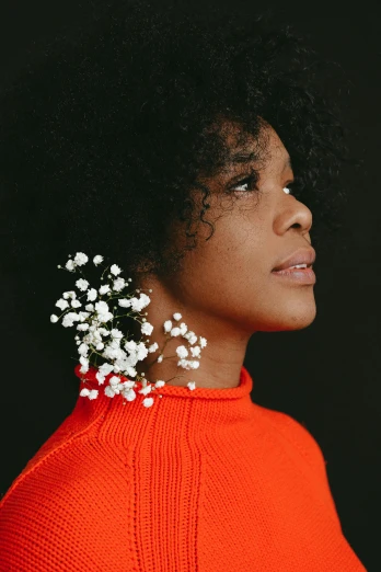 a woman with a flower in her hair, an album cover, by Winona Nelson, trending on unsplash, orange and white color scheme, wearing turtleneck, gypsophila, tessa thompson inspired