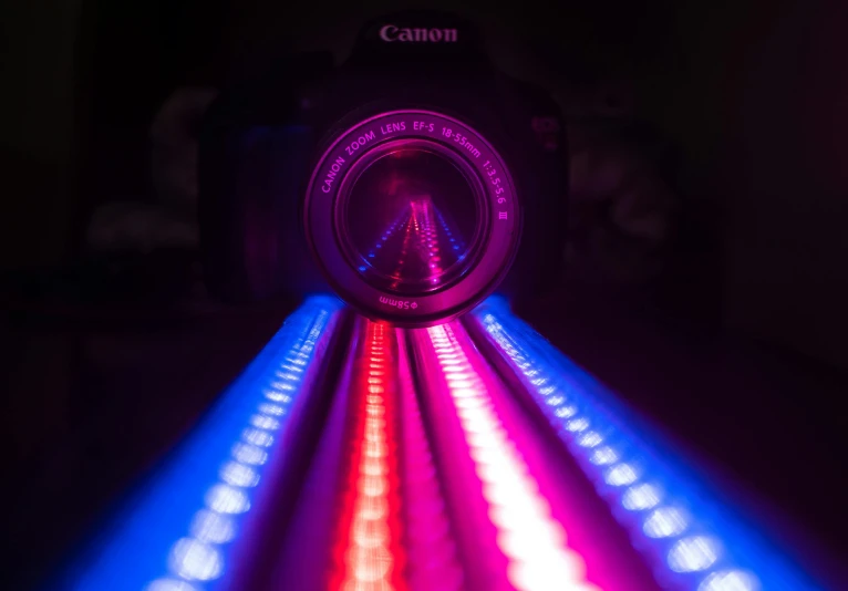 a camera that is sitting on top of a table, by Josh Bayer, pexels contest winner, art photography, glowing tubes, rainbow road, red and blue lighting, taken with a canon dslr camera