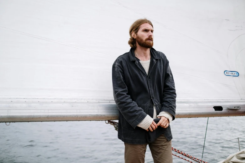 a man standing on the deck of a boat, a portrait, inspired by Ásgrímur Jónsson, unsplash, wearing jacket, bo burnham, he's on an old sailing boat, rugged details