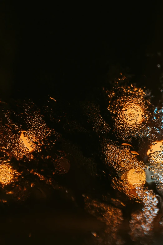 a blurry photo of a street at night, an album cover, trending on unsplash, lyrical abstraction, covered in water drops, glowing gold embers, inside of a car, lava texture