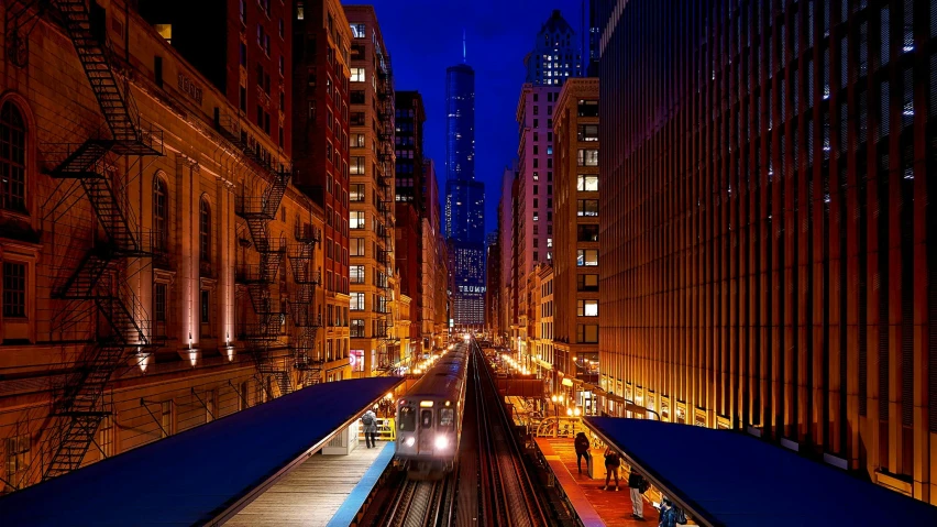 a train traveling down train tracks next to tall buildings, by Chris Cold, blue hour lighting, chicago, 2022 photograph, ad image