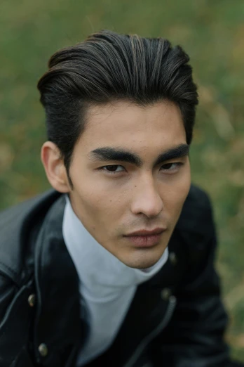 a close up of a person wearing a jacket, inspired by Zhang Han, trending on pexels, slick hair, paul atreides, ethnicity : japanese, androgynous vampire