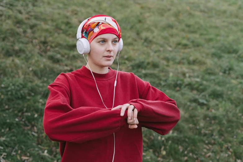 a young boy wearing headphones and listening to music, inspired by Louisa Matthíasdóttir, pexels, renaissance, red sport clothing, wearing a head scarf, wearing a track suit, **cinematic