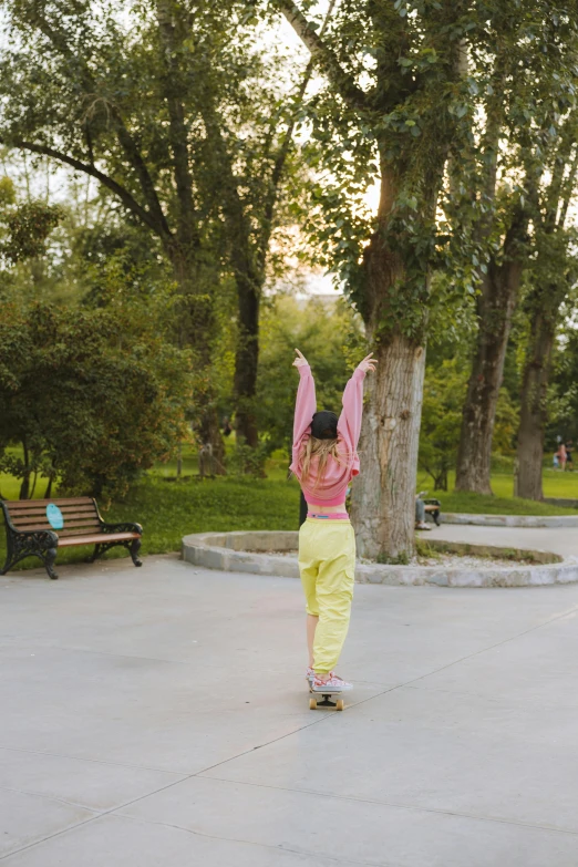 a little girl riding a skateboard in a park, a picture, by Sven Erixson, unsplash, happening, yellow clothes, panoramic view of girl, late summer evening, in a square