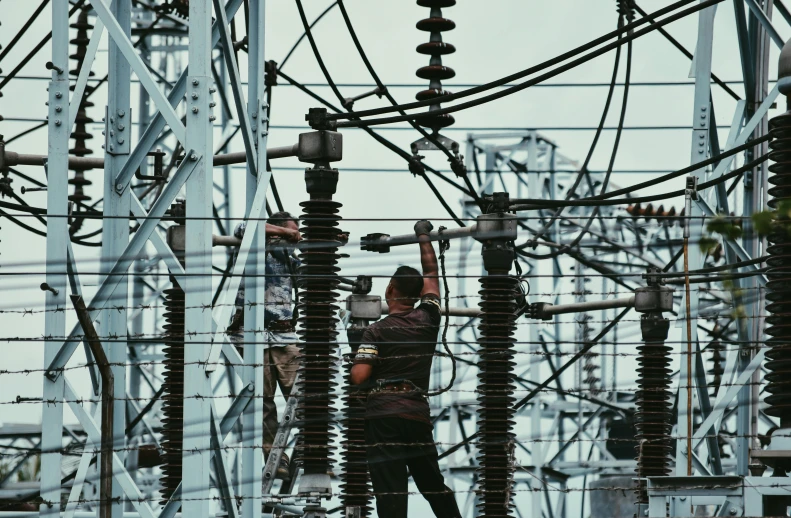 a man standing in the middle of a power line, electrical plant location, instagram post, working, complex and intricate