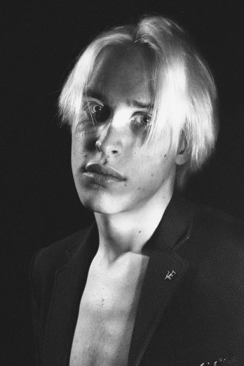 a black and white photo of a man in a suit, a black and white photo, inspired by Sigurd Swane, tumblr, pop art, bleach blonde hair, frank dillane as puck, circa 1 9 8 4, albino skin