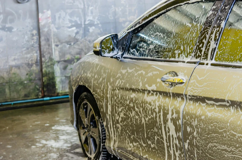 a person washing a car with a hose, by An Gyeon, pexels contest winner, renaissance, liquid gold, in australia, full view of a car, glass and metal : : peugot onyx