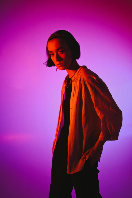 a woman standing in front of a purple background, antipodeans, kiko mizuhara, taken at golden hour, androgyny, ( low key light )