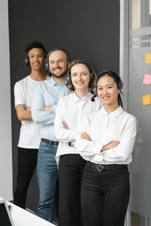 a group of people standing next to each other, wearing a headset, office clothes, varying ethnicities, high-quality photo