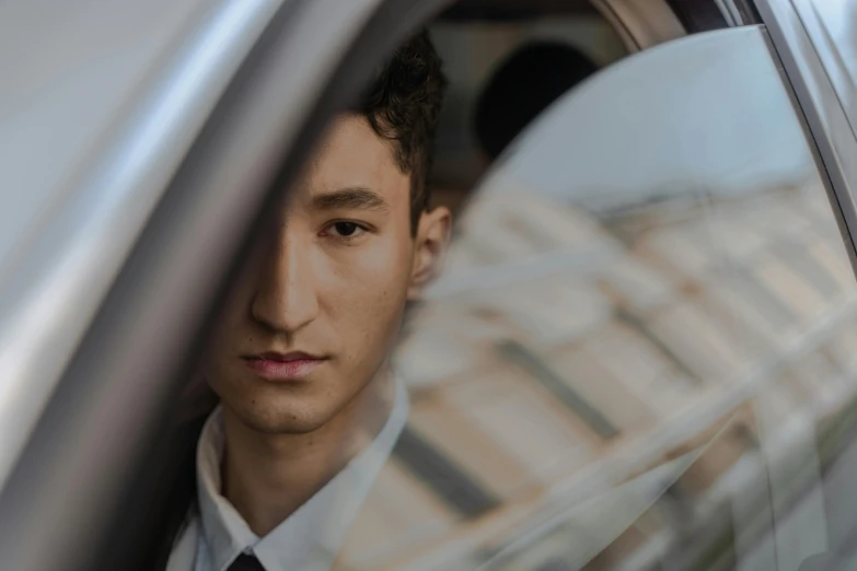 a close up of a person in a car, ethnicity : japanese, professional image, lachlan bailey, thin young male