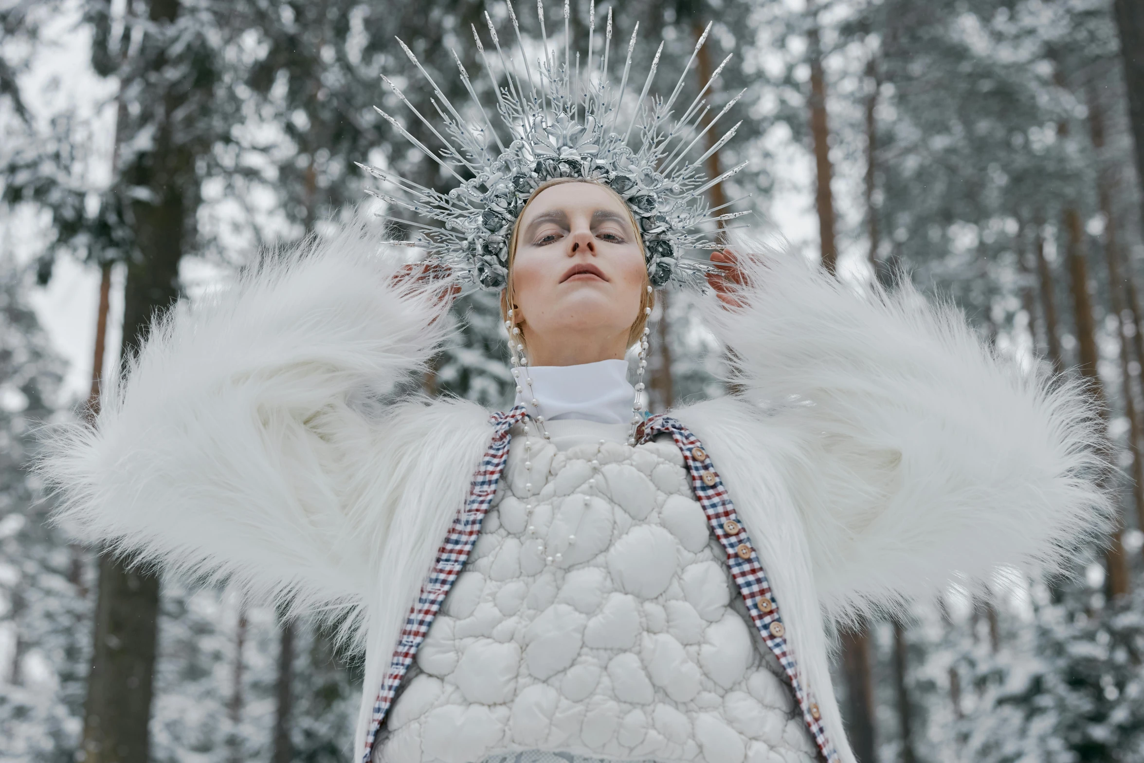 a woman that is standing in the snow, an album cover, inspired by Louisa Matthíasdóttir, pexels contest winner, visual art, jeweled headdress, futuristic fashion show, white puffy outfit, bright nordic forest