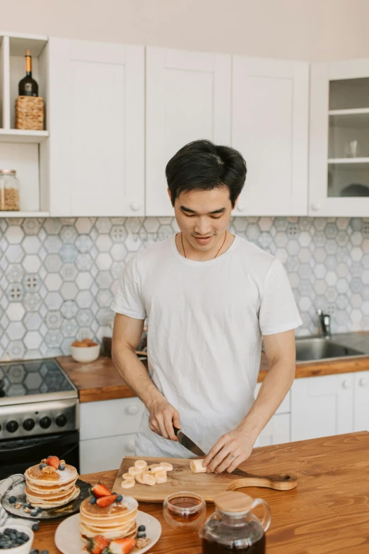 a man standing in a kitchen preparing food, pexels contest winner, happening, asian male, insisted on cutting in line, avatar image, profile image