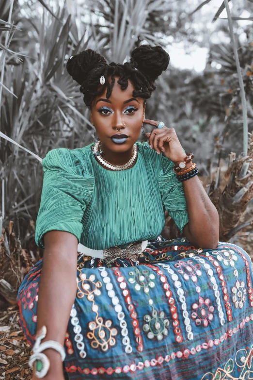 a woman sitting on top of a pile of hay, trending on pexels, afrofuturism, wearing an elegant tribal outfit, teal, natural hair, instagram photo