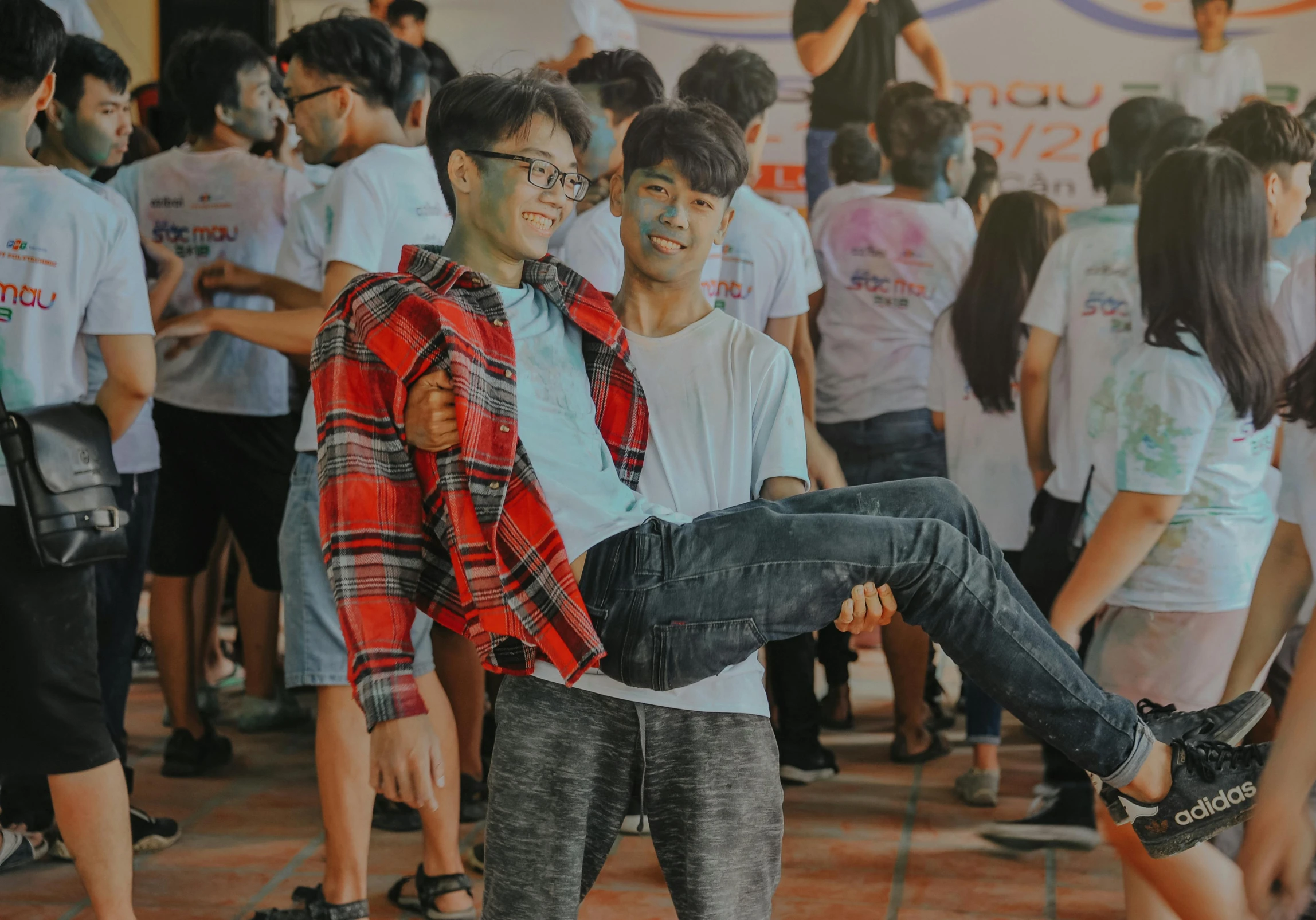 a group of people standing around each other, a picture, pexels contest winner, wearing pants and a t-shirt, asian male, lgbt, background image