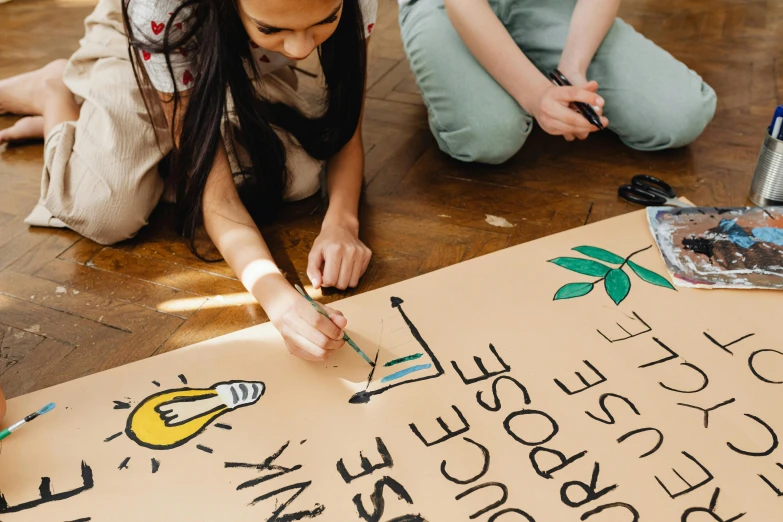 a couple of people that are sitting on the floor, a child's drawing, trending on pexels, woman holding sign, sustainability, banner, made of cardboard