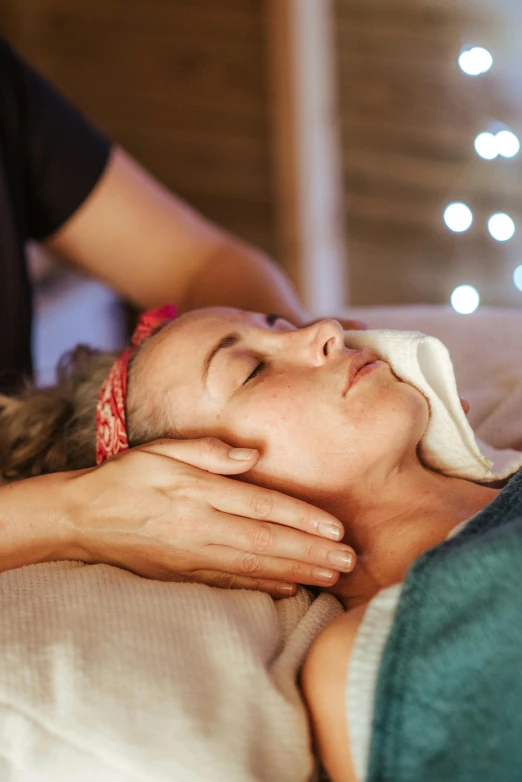 a woman getting a facial massage at a spa, by Julia Pishtar, boho, festive, square, te pae