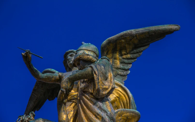 a statue of an angel holding a sword, by Niko Henrichon, pexels contest winner, art nouveau, ultramarine blue and gold, concert, brown, shot on sony a 7 iii