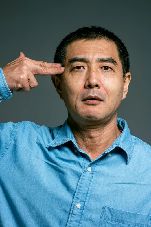 a man in a blue shirt holding his fingers to his ears, inspired by Zhang Xiaogang, pointing at the camera, ernie chan, halfbody headshot, sakuga gunplay