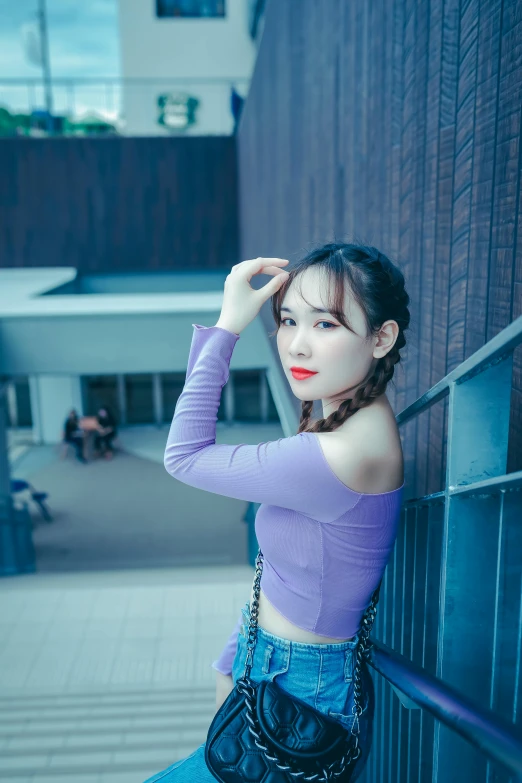 a woman leaning against a wall with her hand on her head, a picture, inspired by Kim Jeong-hui, pexels contest winner, purple top, at a mall, wearing a crop top, 8k selfie photograph
