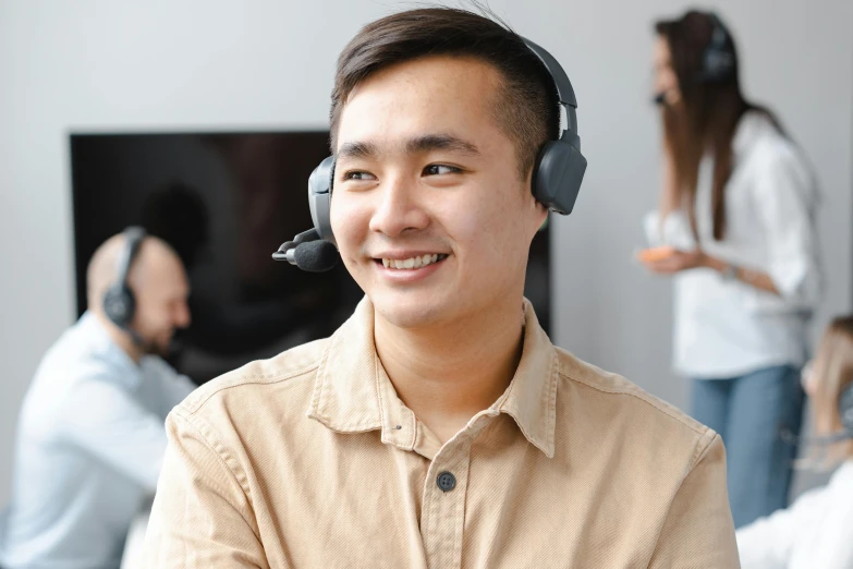 a man wearing a headset in a call center, inspired by Simon Gaon, trending on pexels, shin hanga, smiling at camera, australian, naranbaatar ganbold, male with halo