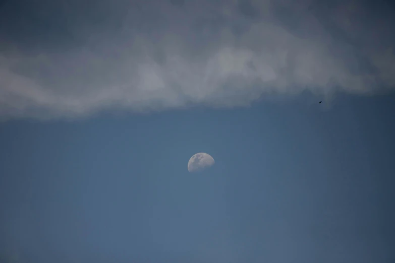 a plane flying in the sky with the moon in the background, by Peter Churcher, unsplash, minimalism, 15081959 21121991 01012000 4k, big smoke clouds visible, 2 0 0 mm telephoto, seen from afar