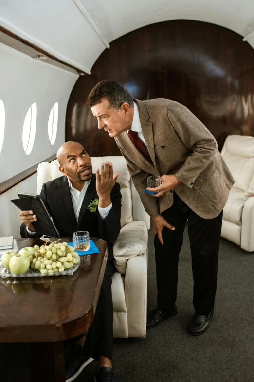 a couple of men standing next to each other in a room, airplane, wealthy, jemal shabazz, inspect in inventory image